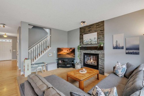 104 Prestwick Street Se, Calgary, AB - Indoor Photo Showing Living Room With Fireplace