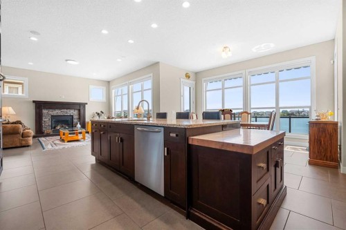 54 Auburn Sound Place Se, Calgary, AB - Indoor Photo Showing Kitchen With Fireplace With Double Sink