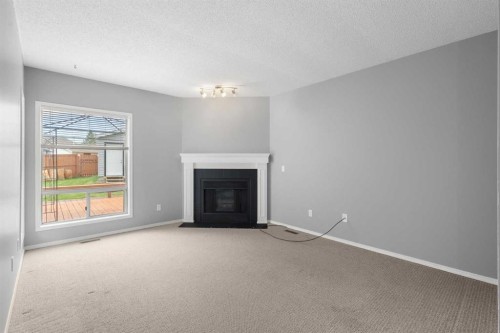 256 Covington Place Ne, Calgary, AB - Indoor Photo Showing Living Room With Fireplace