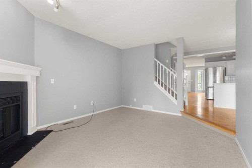 256 Covington Place Ne, Calgary, AB - Indoor Photo Showing Other Room With Fireplace