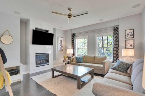 145 Marquis Common Se, Calgary, AB - Indoor Photo Showing Living Room With Fireplace