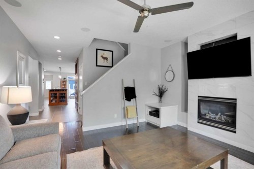145 Marquis Common Se, Calgary, AB - Indoor Photo Showing Living Room With Fireplace