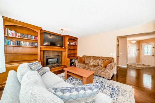 327 Hidden Ranch Circle Nw, Calgary, AB - Indoor Photo Showing Living Room With Fireplace