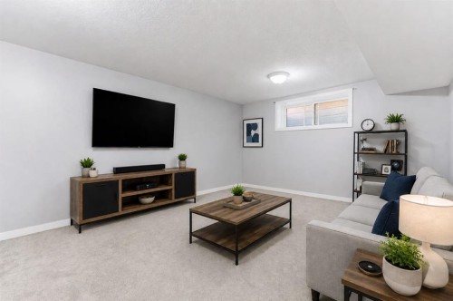 394 Copperpond Boulevard Se, Calgary, AB - Indoor Photo Showing Living Room