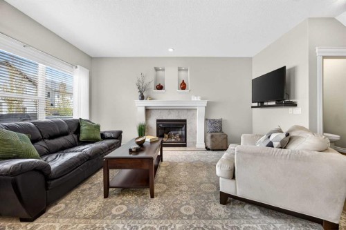 293 Bridleridge View Sw, Calgary, AB - Indoor Photo Showing Living Room With Fireplace