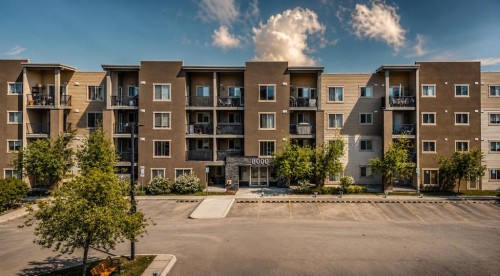 8112-403 Mackenzie Way Se, Airdrie, AB - Outdoor With Facade