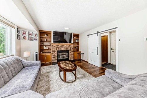 81 Eldorado Close Ne, Calgary, AB - Indoor Photo Showing Living Room With Fireplace
