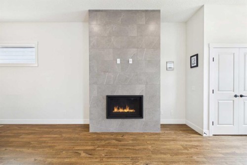 11 Royston Park Nw, Calgary, AB - Indoor Photo Showing Living Room With Fireplace