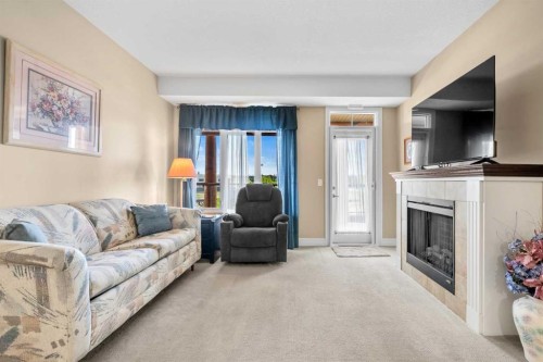 2303-2330 Fish Creek Boulevard Sw, Calgary, AB - Indoor Photo Showing Living Room With Fireplace