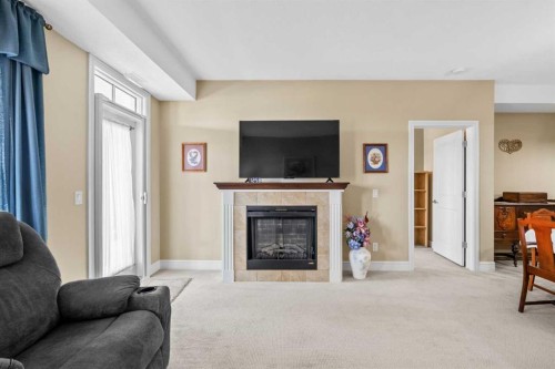 2303-2330 Fish Creek Boulevard Sw, Calgary, AB - Indoor Photo Showing Living Room With Fireplace