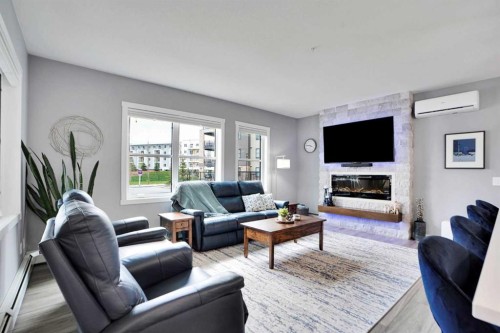 105-55 Wolf Hollow Crescent Se, Calgary, AB - Indoor Photo Showing Living Room With Fireplace