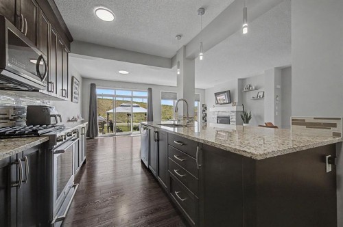 53 Fireside Crescent, Cochrane, AB - Indoor Photo Showing Kitchen With Upgraded Kitchen