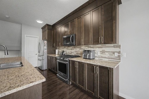 53 Fireside Crescent, Cochrane, AB - Indoor Photo Showing Kitchen With Double Sink With Upgraded Kitchen