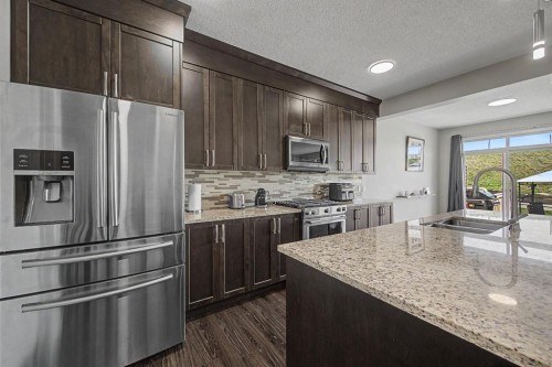 53 Fireside Crescent, Cochrane, AB - Indoor Photo Showing Kitchen With Double Sink With Upgraded Kitchen