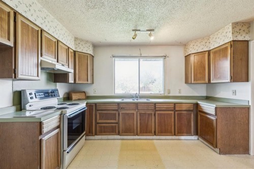 1132 Hunterston Hill Nw, Calgary, AB - Indoor Photo Showing Kitchen With Double Sink