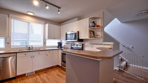 20 Tuscany Valley Park Nw, Calgary, AB - Indoor Photo Showing Kitchen With Double Sink