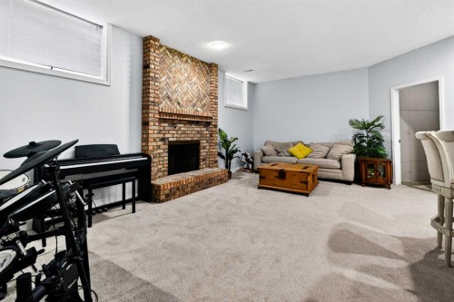 876 Shawnee Drive Sw, Calgary, AB - Indoor Photo Showing Living Room With Fireplace