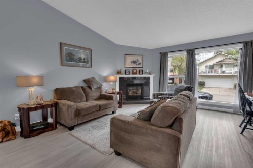 67 Deersaxon Circle Se, Calgary, AB - Indoor Photo Showing Living Room With Fireplace