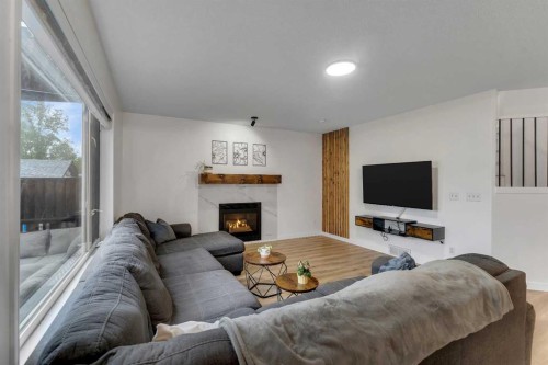 46 Wilson Road Ne, Langdon, AB - Indoor Photo Showing Living Room With Fireplace