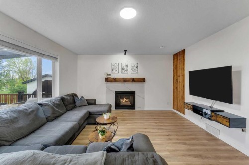 46 Wilson Road Ne, Langdon, AB - Indoor Photo Showing Living Room With Fireplace