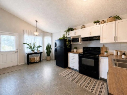 129 Cimarron Grove Circle, Okotoks, AB - Indoor Photo Showing Kitchen With Double Sink