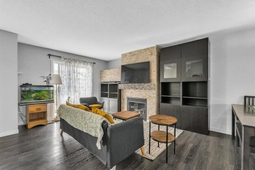 425 Copperpond Landing Se, Calgary, AB - Indoor Photo Showing Living Room With Fireplace