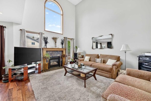 192 Arbour Wood Close Nw, Calgary, AB - Indoor Photo Showing Living Room With Fireplace