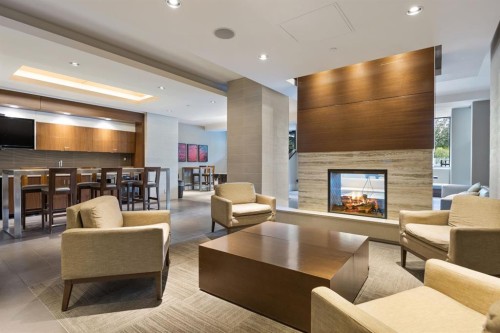 47 Waterfront Mews Sw, Calgary, AB - Indoor Photo Showing Living Room With Fireplace