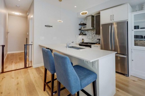 111-408 27 Avenue Ne, Calgary, AB - Indoor Photo Showing Kitchen With Double Sink With Upgraded Kitchen