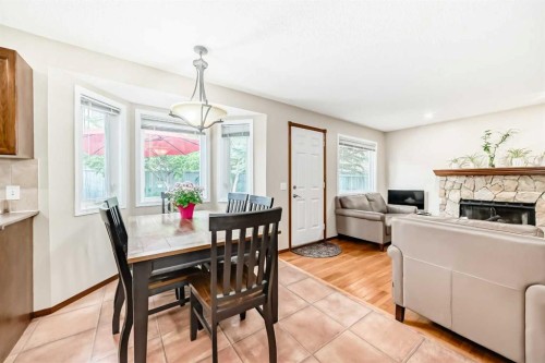 232 Macewan Ridge Close Nw, Calgary, AB - Indoor Photo Showing Dining Room With Fireplace