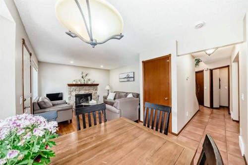 232 Macewan Ridge Close Nw, Calgary, AB - Indoor Photo Showing Dining Room With Fireplace