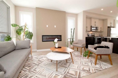 3 Sunrise Heights, Cochrane, AB - Indoor Photo Showing Living Room With Fireplace