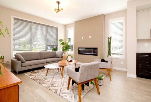 3 Sunrise Heights, Cochrane, AB - Indoor Photo Showing Living Room With Fireplace
