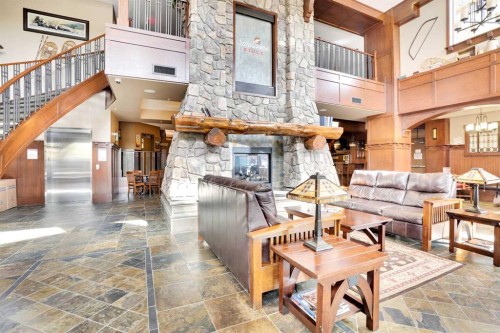 1132-2330 Fish Creek Boulevard Sw, Calgary, AB - Indoor Photo Showing Living Room With Fireplace