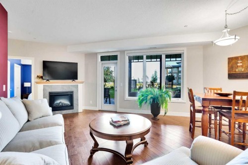 1132-2330 Fish Creek Boulevard Sw, Calgary, AB - Indoor Photo Showing Living Room With Fireplace