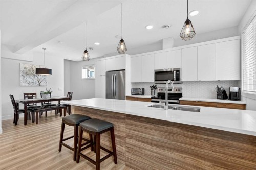 33-230 Seton Passage Se, Calgary, AB - Indoor Photo Showing Kitchen With Stainless Steel Kitchen With Double Sink With Upgraded Kitchen