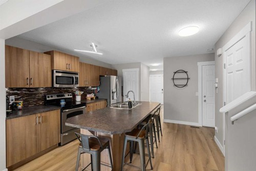 105 Sunset Common, Cochrane, AB - Indoor Photo Showing Kitchen With Stainless Steel Kitchen With Double Sink