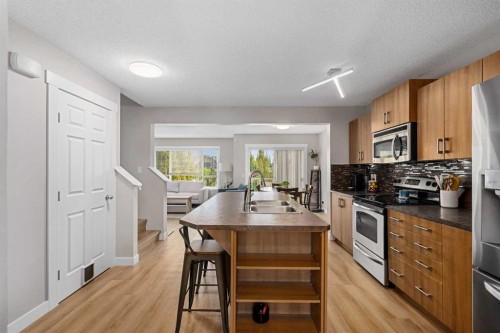 105 Sunset Common, Cochrane, AB - Indoor Photo Showing Kitchen With Stainless Steel Kitchen