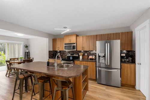 105 Sunset Common, Cochrane, AB - Indoor Photo Showing Kitchen With Stainless Steel Kitchen With Double Sink