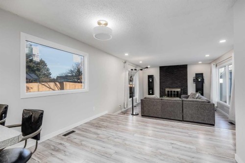 3394 Breton Close Nw, Calgary, AB - Indoor Photo Showing Other Room With Fireplace