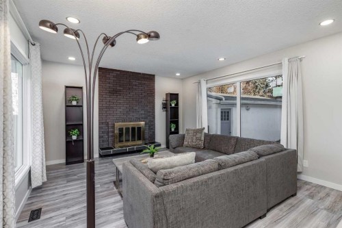 3394 Breton Close Nw, Calgary, AB - Indoor Photo Showing Living Room With Fireplace