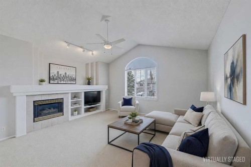 36 Mt Selkirk Close Se, Calgary, AB - Indoor Photo Showing Living Room With Fireplace