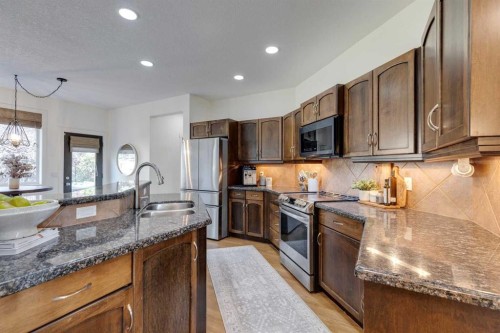107 Aspen Stone Crescent Sw, Calgary, AB - Indoor Photo Showing Kitchen With Double Sink
