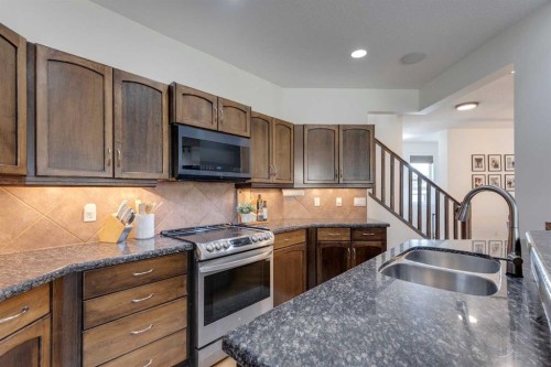 107 Aspen Stone Crescent Sw, Calgary, AB - Indoor Photo Showing Kitchen With Double Sink