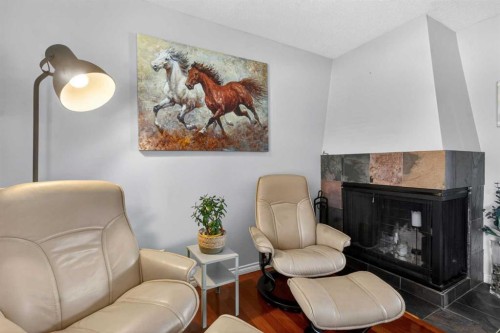 348 Midlake Boulevard Se, Calgary, AB - Indoor Photo Showing Living Room With Fireplace