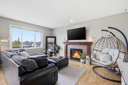 99 Sunset View, Cochrane, AB - Indoor Photo Showing Living Room With Fireplace