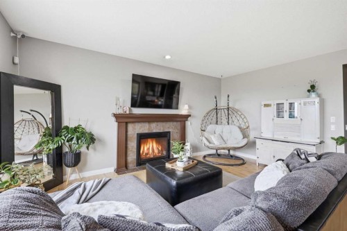 99 Sunset View, Cochrane, AB - Indoor Photo Showing Living Room With Fireplace