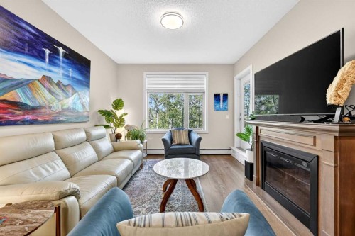 216-35 Aspenmont Heights Sw, Calgary, AB - Indoor Photo Showing Living Room With Fireplace