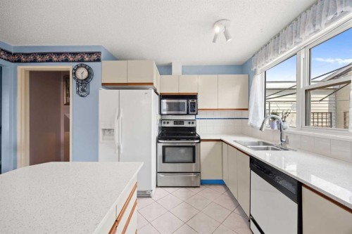 452 Manora Way Ne, Calgary, AB - Indoor Photo Showing Kitchen With Double Sink