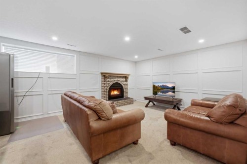 84 Coach Gate Way Sw, Calgary, AB - Indoor With Fireplace